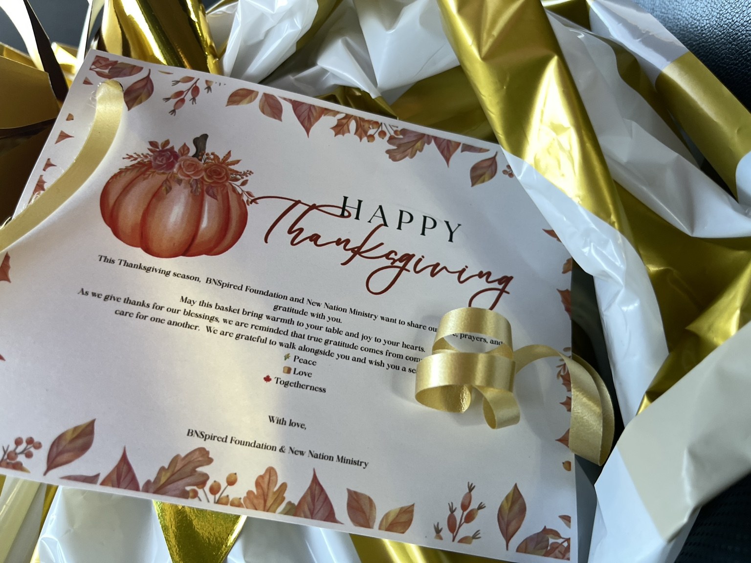 A Thanksgiving greeting tucked into a wrapped meal package.
