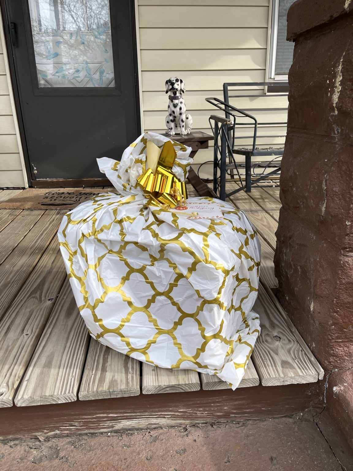 A wrapped meal package on a porch.